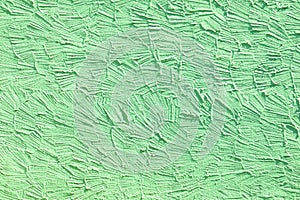 Green wall background with structure of plaster