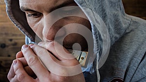 Harmonica in the hands of a man