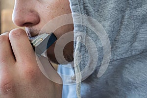 Harmonica in the hands of a man