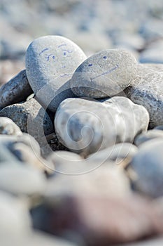 A harmonious background or closeup of smooth natural rocks or round beach pebbles at the beach