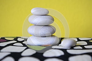 Harmony and balance, cairn, poise stones, rock zen sculpture, three white pebbles