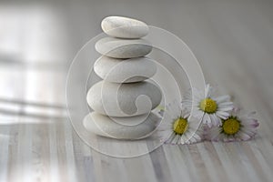 Harmony and balance, cairns, simple poise pebbles on wooden light white gray background, simplicity rock zen sculpture