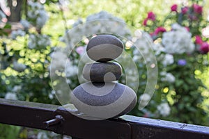 Harmony and balance, cairns, simple poise stones in the garden, rock zen sculpture, dark grey pebbles