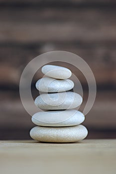 Harmony and balance, cairns, simple poise stones on white background, rock zen sculpture, five white pebbles, single tower