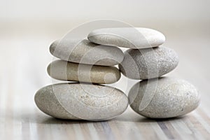 Harmony and balance, cairns, simple poise stones on wooden light white gray background, simplicity rock zen sculpture