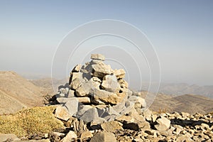 Harmony and balance, poise stones against the blue sky in the mountains, rock zen sculpture