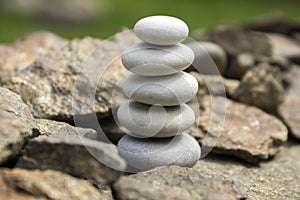 Harmony and balance, simple pebbles tower in another pebbles, simplicity, five stones