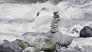 Harmony, balance and simplicity concept. Creative. A stone pyramid on the background of river water.