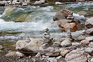 Harmony, balance and simplicity concept. A stone pyramid with a river in the background