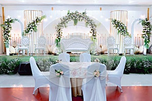 Harmony in White: Muslim Wedding Akad with Gebyok and Floral Delights