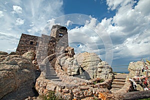 Harney Peak Fire Lookout Tower with Native American prayer flags under cirrus cumulus cloudscape