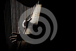 Harp player. Harpist hands playing Irish harp strings