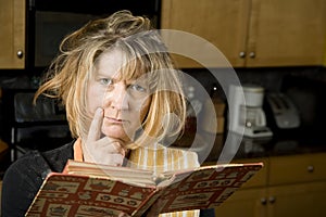 Harried woman with recipe book
