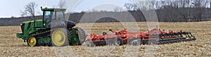 John Deere 9560RT tracked tractor pulling a KUHN 8010 Excelerator XT vertical tillage system