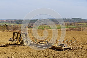 Harrows in the field will cultivate the land before sowing fertilizers.