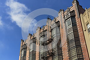 Harsh light, sun flare old art deco building, blue sky