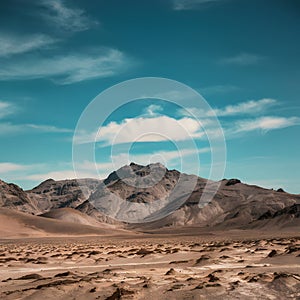 A harsh, solitary desert with jagged peaks under a vast blue sky.