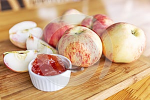 Harvest beautiful apples with red barrels and jam from them. Still life on a wooden board on the table