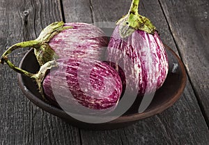 Harvest of eggplant graffiti on a dark wooden background