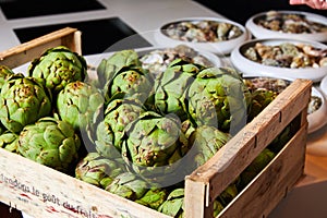 Harvest of exotic artichoke in box in restaurant kitchen
