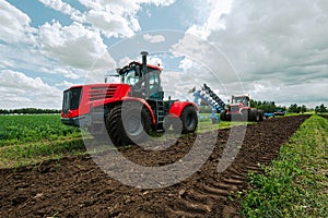 harvest field with red tractor mods dry grass. field after harvest. Harvesting in the fields. Stock up on hay for winter