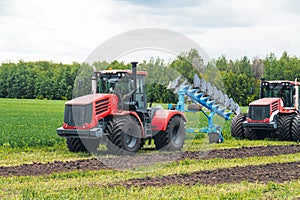 harvest field with red tractor mods dry grass. field after harvest. Harvesting in the fields. Stock up on hay for winter