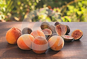 Harvest fresh ripe peaches and figs on an wooden table