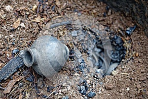 Harvest of pottery after burning in a replica of an ancient pit fire kiln