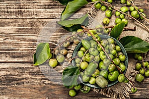 Harvest of ripe Actinidia arguta kiwi in a ceramic bowl