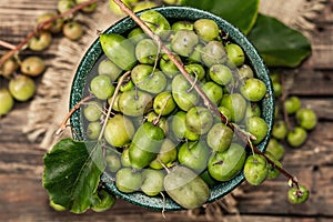 Harvest of ripe Actinidia arguta kiwi in a ceramic bowl