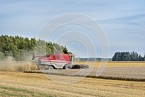 Harvest season, combine for harvesting a wheat field. Combine harvester is an agricultural machine that harvests ripe