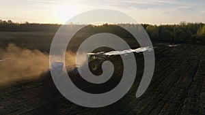 Harvest spring sunset combine field landscape Ukraine aerial green