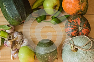 Harvest or Thanksgiving background with autumn fruits and gourds on a rustic wooden table