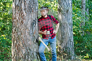 Harvest of timber. Bearded man with axe concept. Deforestation. Handsome Woodworkers lumberjack plaid shirt holding the
