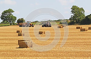 Harvest time. Corn stubble and bales of straw.
