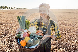 Harvest time in the country, woman farmer offering vegetables