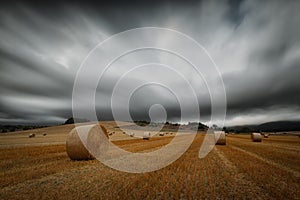 Harvest time, straw bales in a cloudy day at Gordoa, Alava