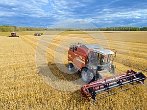 Harvest wheat grain and crop aerial view.Harvesting wheat,oats, barley in fields,ranches and farmlands.Combines mow in the field. photo