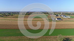 Harvested Corn Fields and Rolled Corn Stalks and Amish Farm Steads on a Sunny Autumn Day