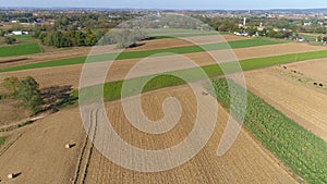 Harvested Corn Fields and Rolled Corn Stalks and Amish Farm Steads on a Sunny Autumn Day