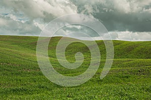 Harvested Fields and meadows landscape in Tuscany, Italy. Wavy country scenery at autumn sunset.