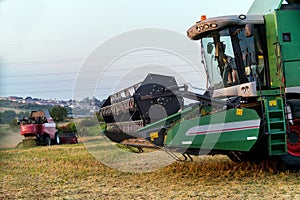 Harvester combine autumn graine wheat farmer worker plantation technology green field