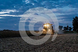 Harvester combine at dusk, Illinois