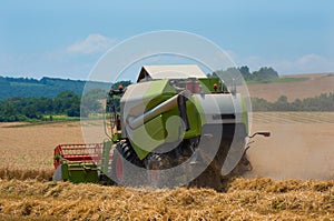 Harvester combine harvesting wheat.