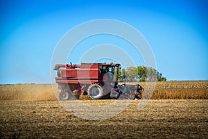 Harvester harvesting corn in a field in the fall in Quebec