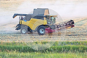 The harvester is harvesting wheat in the field. grain preparation. agronomy and agriculture