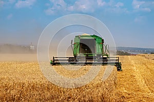 Harvester machine to harvest wheat field working. Combine harvester agriculture machine harvesting wheat field