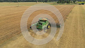 Harvester machine working in wheat field, agricultural machines working
