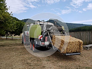 a harvester that pulls hay from the fields and turns it into briquettes