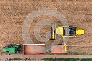 Harvester and tractor harvesting wheat